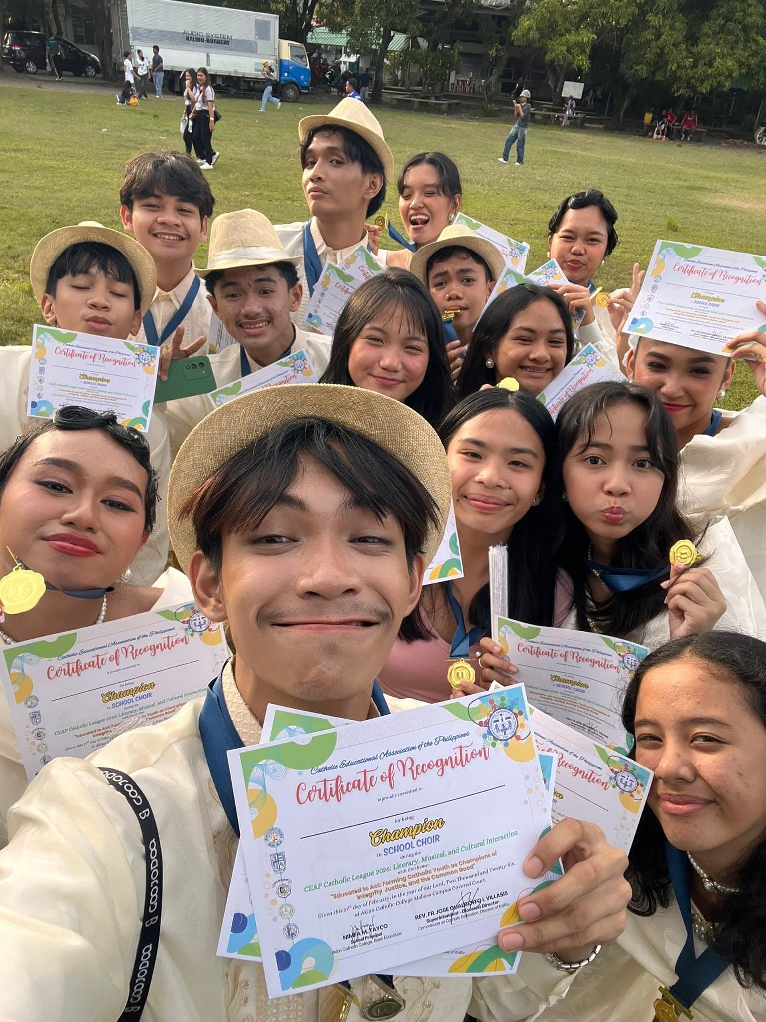Guardians of the school choir celebrate their Catholic League championship, certificates and medals in hand.
