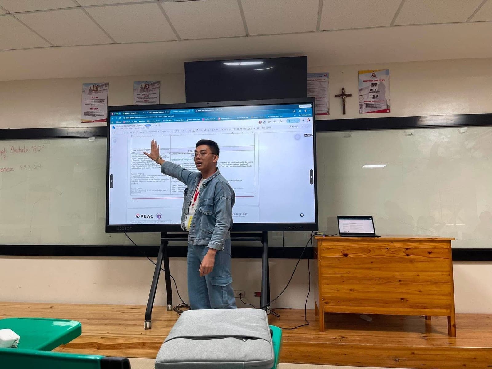 A participant presenting a learning plan on a large classroom screen during a session
